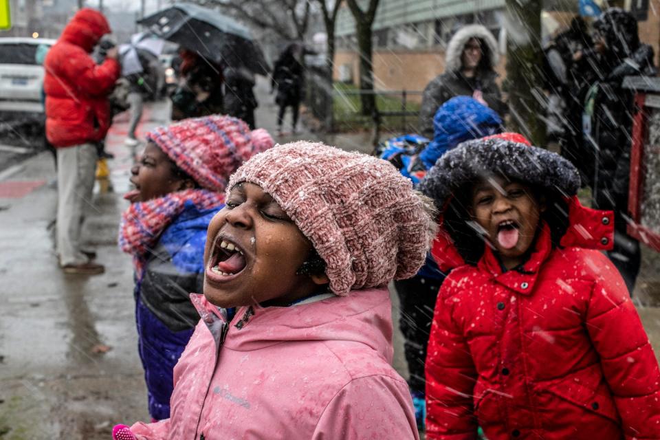 Madison sticks out her tongue to catch snowflakes with her friends as they wait outside to be picked out from their school, Edmonson Elementary in Detroit on Friday, Jan. 12, 2024. Moderate to heavy, wet snow is expected to hit parts of Southeast Michigan, most of it missing metro Detroit.