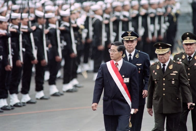 Former Peruvian president Alberto Fujimori, pictured reviewing a guard of honor while in office in 1995. He died on Wednesday at the age of 86 in Lima (Jaime RAZURI)