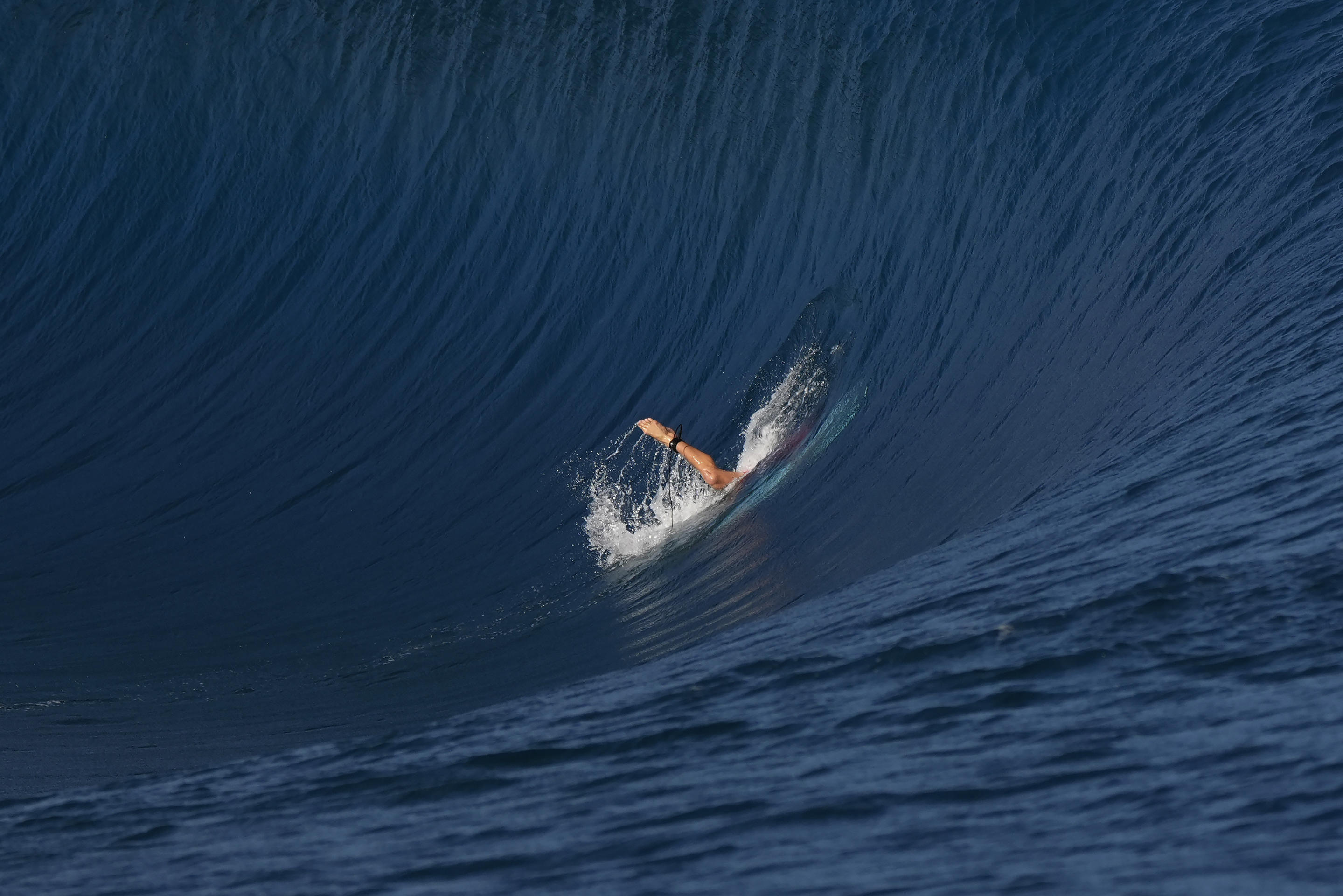 Griffin Colapinto, of the United States, dives into a wave during the third round of the 2024 Summer Olympics surfing competition Monday, July 29, 2024, in Teahupo'o, Tahiti. (Gregory Bull/AP)