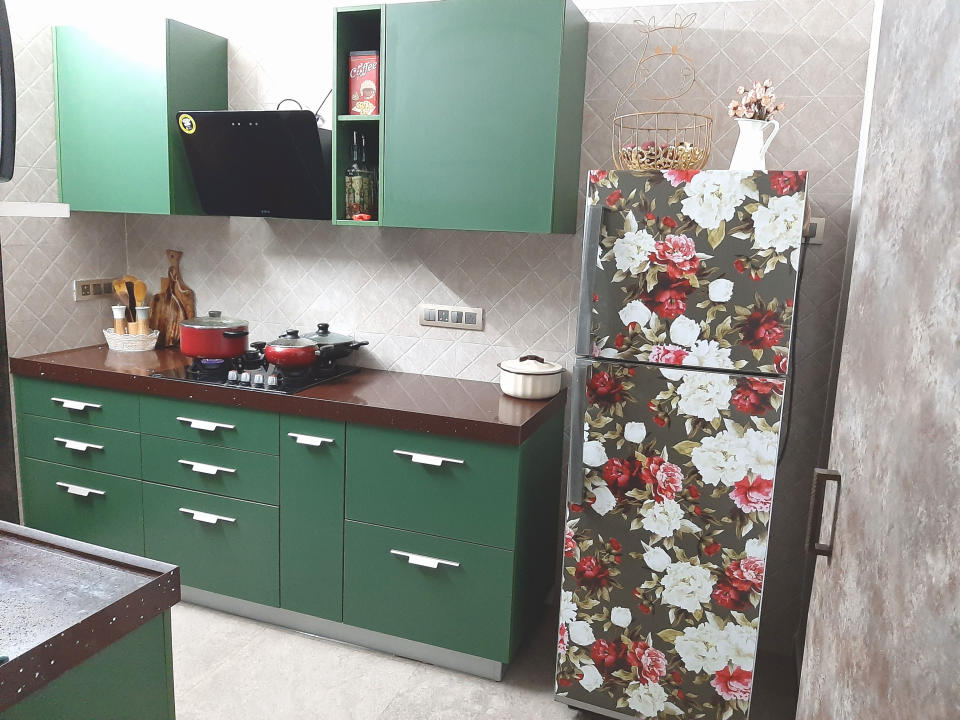 The kitchen pops in teal, laminated cabinets and a floral-clad refrigerator. The latter is yet another DIY project, executed using a downloadable pattern, printed on vinyl.