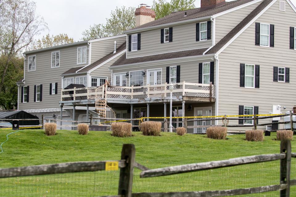 Crime scene tape surrounds an Upper Makefield home where two brothers, 9 and 13 years old, were shot Monday morning. Their mother, 38-year-old Trinh Nguyen, was arrested and charged in the shooting, according to Bucks County District Attorney Matthew Weintraub.