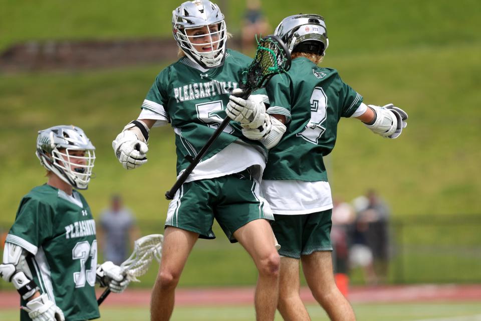 Pleasantville's Erik Coleman (5) and Nick Reich (2) celebrate a first=half goal by Coleman against Briarcliff, during boys lacrosse action at Briarcliff High School May 13, 2023.