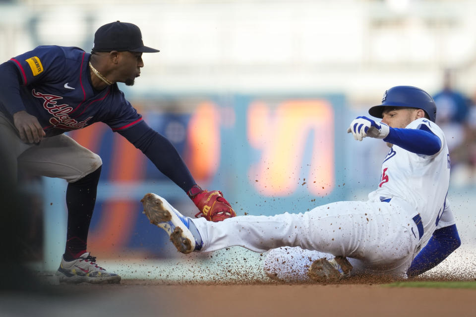 Los Angeles Dodgers' Freddie Freeman, right, is out at second with a tag by Atlanta Braves second baseman Ozzie Albies during the third inning of a baseball game in Los Angeles, Saturday, May 4, 2024. (AP Photo/Ashley Landis)
