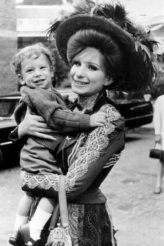 <p>Stanley Bielecki Movie Collection/Getty</p> Jason Gould on the set of 'Hello Dolly!' with mom Barbra Streisand in 1969