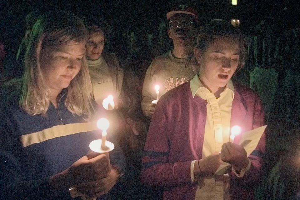 FILE - Students appear at a vigil against violence at Prexy's Pasture on the University of Wyoming campus in Laramie, Wyo., on Oct. 10, 1999. The weekend marked the one-year anniversary death of Matthew Shepard, a gay University of Wyoming student, who was tied to a fence and beaten into a coma from which he died two days later on Oct. 7, 1998. The Tectonic Theater Project is marking the anniversary by gathering the original cast and creators of "The Laramie Project," and some of the people represented in the piece for a staged reading and conversation as part of the 2023 Shepard Symposium at the University of Wyoming. (AP Photo/Ed Andrieski, File)