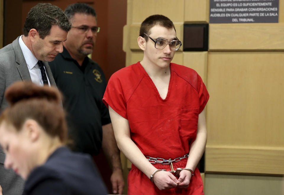 Florida school shooting defendant Nikolas Cruz enters the courtroom for a hearing at the Broward Courthouse, Tuesday, Dec. 10, 2019, in Fort Lauderdale, Fla. Broward Circuit Judge Elizabeth Scherer set a Dec. 19 date for arguments on the motion by defense lawyers who claim the case is moving much too swiftly and runs the risk of legal errors. That could mean a conviction of Cruz might be reversed on appeal, sending it back for another trial. (Amy Beth Bennett/South Florida Sun-Sentinel via AP, Pool)