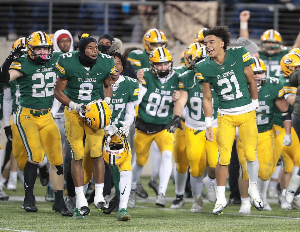 St. Edward players run on the field in the last seconds of their win over Springfield for the Division I state championship game at Tom Benson Hall of Fame Stadium in Canton, Friday, Dec. 2, 2022.