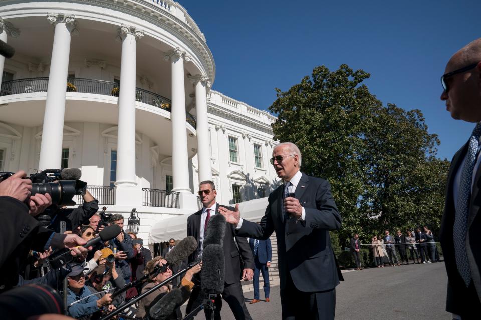 President Joe Biden talks with reporters before boarding Marine One on the South Lawn of the White House in Washington, Friday, Oct. 21, 2022. Biden is traveling to Delaware State University in Dover, Del., to speak about his plan for student debt relief.