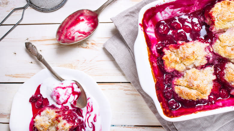 cherry cobbler on plate and in pan