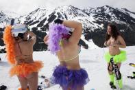 (L to R) Natasha Aslani, Annie Kearby, and Megan Craft prepare to compete in the Bikini & Board Shorts Downhill at Crystal Mountain, a ski resort near Enumclaw, Washington April 19, 2014. Skiers and snowboarders competed for a chance to win one of four season's passes. REUTERS/David Ryder (UNITED STATES - Tags: SPORT SNOWBOARDING SKIING SOCIETY)