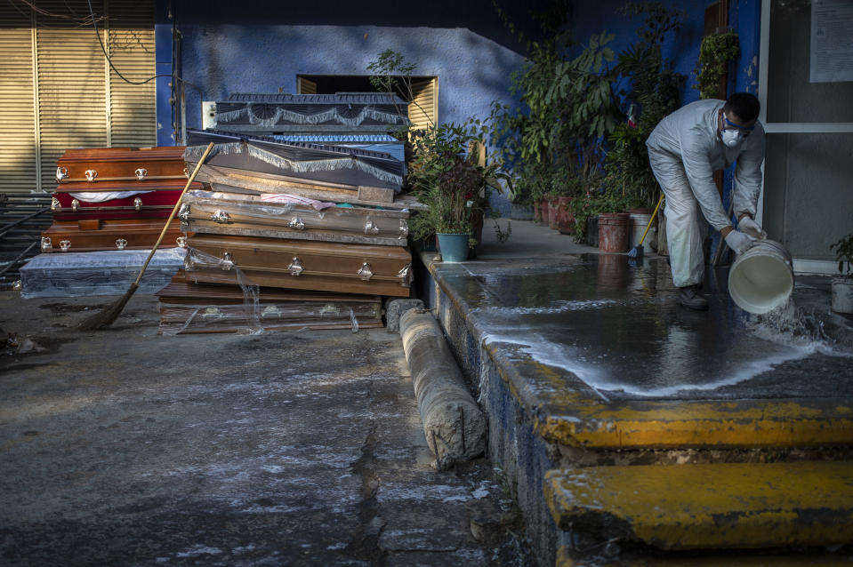 MEXICO CITY, MEXICO - MAY 8: A worker of the Xilotepec cemetery in Xochimilco cleans the unloading area before receiving corpses of Covid-19 victims as the are stored for destruction on May 8, 2020 in Mexico City, Mexico. Mexico is on Stage Three of health emergency, as deaths and positive cases grow. According to Health Ministry, Mexico faces the most dangerous week with an exponential spread of contagion. While only essential activities are permitted, government suggests population to stay at home but quarantine is not obligatory as there is major concern about the economic activity. Social distancing measures could be over between May 18 and 30. (Photo by Cristopher Rogel Blanquet/Getty Images)