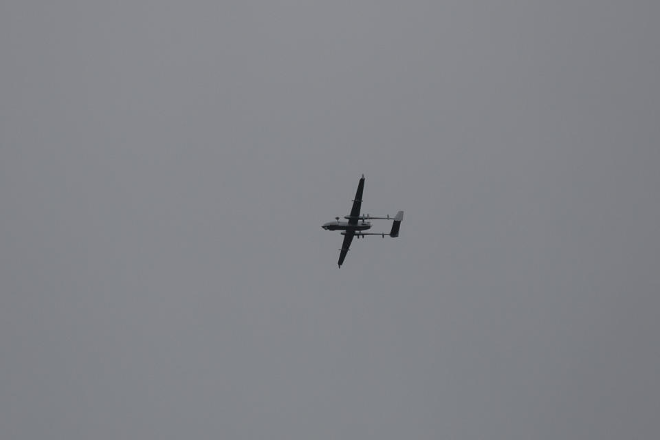 A drone belonging to the Indian army flies above as police and army soldiers launch an operation in Awantipora area, south of Srinagar, Indian controlled Kashmir, Wednesday, May 6, 2020. Government forces killed a top rebel commander and his aide in Indian-controlled Kashmir on Wednesday and shut down cellphone and mobile internet services during subsequent anti-India protests, officials, and residents said. (AP Photo/ Dar Yasin)