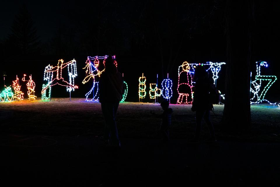 A family views the "12 Days of Christmas" light display at a past "The Gift of Lights" event at Potawatomi Zoo in South Bend. The 2022 event runs from Nov. 25 to Dec. 18.