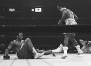 FILE - Joe Frazier stands over Muhammad Ali in the 15th round of their boxing match at Madison Square Garden in New York, in this March 8, 1971, file photo. They fought for 15 rounds, furiously at times, with Frazier moving forward in a crouch throwing big left hooks while Ali shot out fast jabs and right hands to counter him coming in.(AP Photo/File)