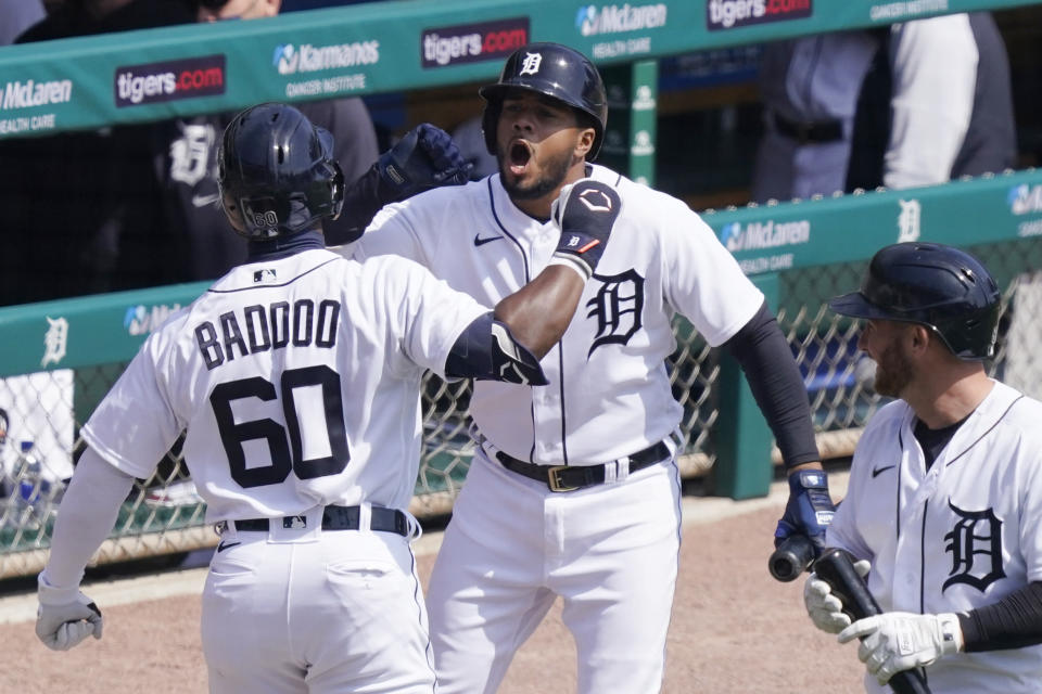 Detroit Tigers' Akil Baddoo (60) is greeted by Jeimer Candelario after hitting a solo home run during the third inning of a baseball game against the Cleveland Indians, Sunday, April 4, 2021, in Detroit. (AP Photo/Carlos Osorio)