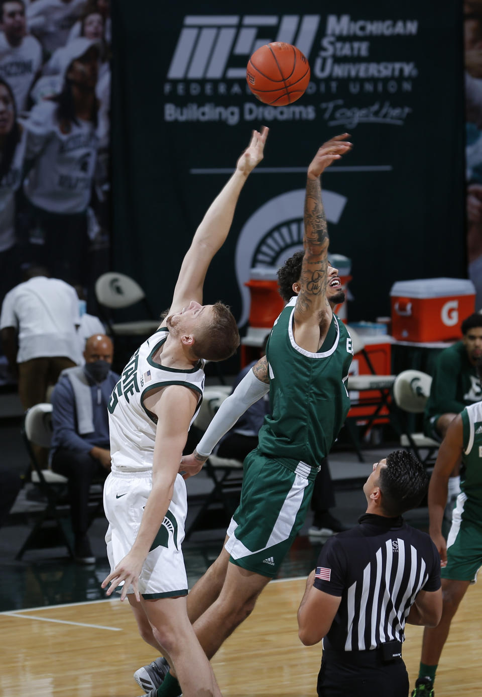 Michigan State's Thomas Kithier, left, and Eastern Michigan's Ty Groce leap for the tip to begin an NCAA college basketball game Wednesday, Nov. 25, 2020, in East Lansing, Mich. Michigan State won 83-67. (AP Photo/Al Goldis)