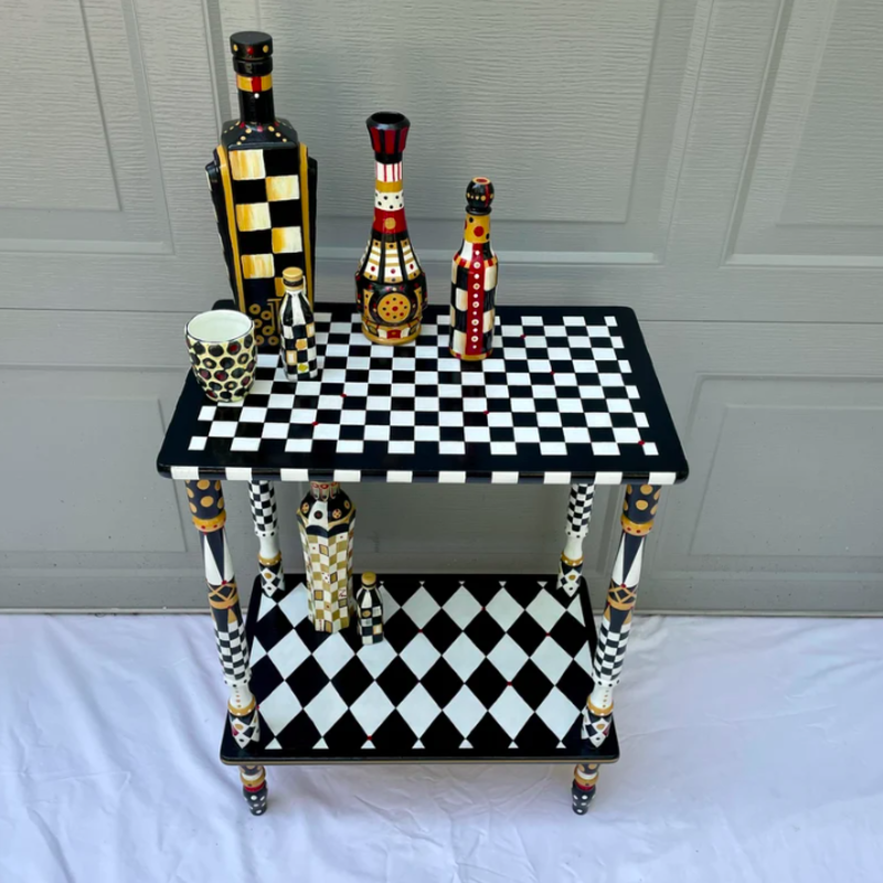 The small checkered table 100% handpainted.<p><a href="https://www.etsy.com/listing/1545475892/whimsical-painted-tableo-black-and-white" rel="nofollow noopener" target="_blank" data-ylk="slk:Etsy / KelloggCuriosities;elm:context_link;itc:0;sec:content-canvas" class="link ">Etsy / KelloggCuriosities</a></p>