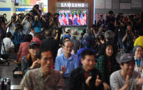 <p>People watch a television screen showing live footage of the summit between President Donald Trump and North Korean leader Kim Jong Un in Singapore, at a railway station in Seoul on June 12, 2018. (Photo: Jung Yeon-je/AFP/Getty Images) </p>