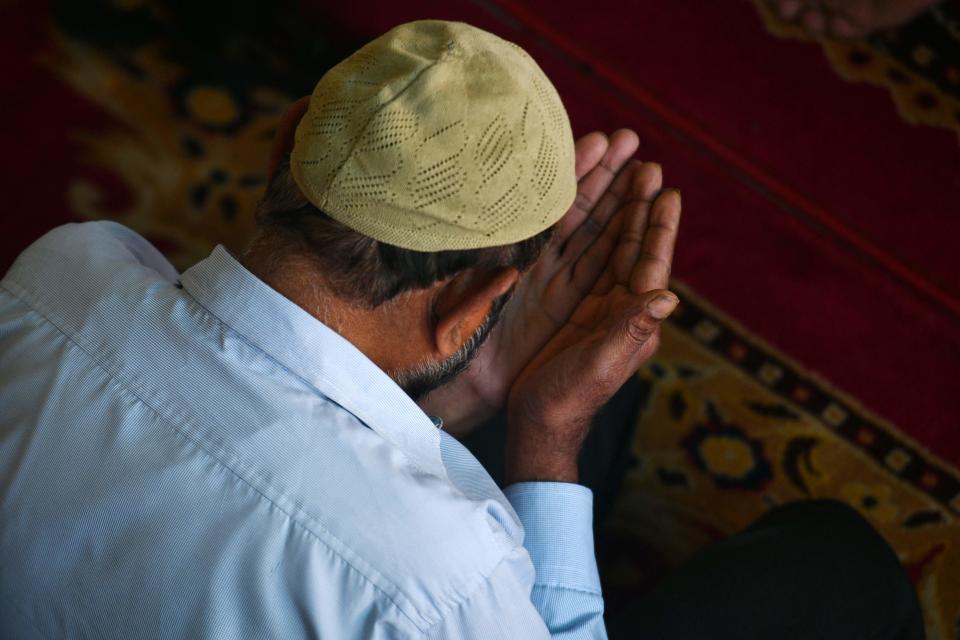 A Muslim devotee offers special morning prayers to start the Eid al-Fitr festival, which marks the end of their holy fasting month of Ramadan, at the Kashmiri Mosque in Kathmandu on April 22, 2023.