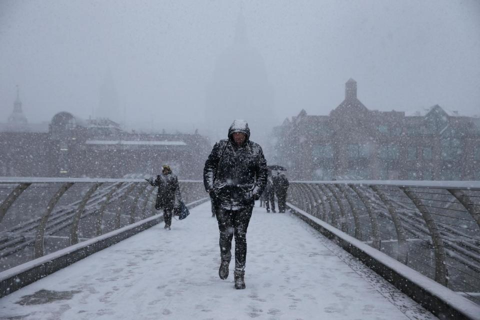 Pedestrians walk across millennium bridge during a cold snap in 2018 (AFP/Getty Images)