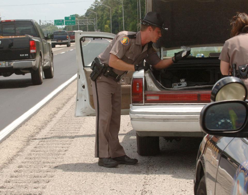A Florida Highway Patrol trooper searches the trunk of a car stopped on Interstate 295 over suspected drug crimes in this photo from 2006.