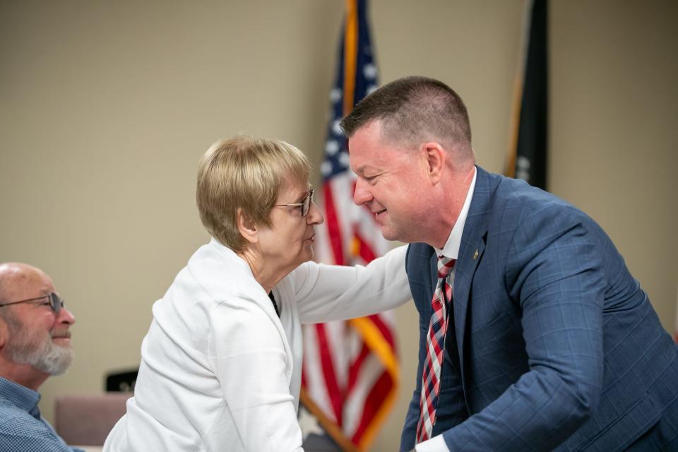 Psychologist Jeffrey Bates is congratulated by friend and neighbor Denise McNulty before he is sworn in as a captain in the U.S. Army Reserve on Feb. 15 at the Veterans Service Center in Ocala. Bates has been working with soldiers at the VA for years and wanted to join the Army Reserve and extend his service to veterans.