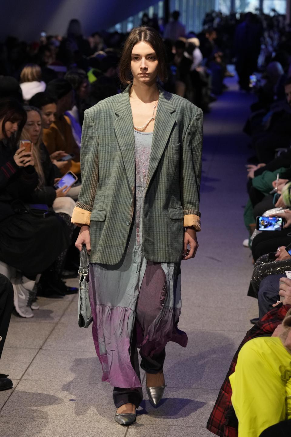 A model wears a creation part of the men's Simon Cracker Fall-Winter 2024-2025 collection, that was presented in Milan, Italy, Sunday, Jan. 14, 2024. (AP Photo/Antonio Calanni).