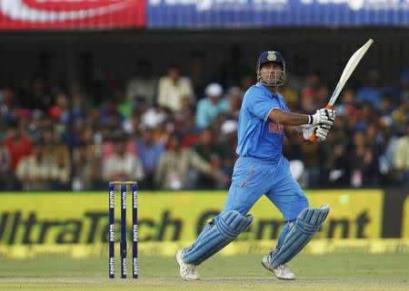 India's captain Mahendra Singh Dhoni hits a shot during their second one-day international cricket match against South Africa in Indore, India, October 14, 2015. REUTERS/Danish Siddiqui