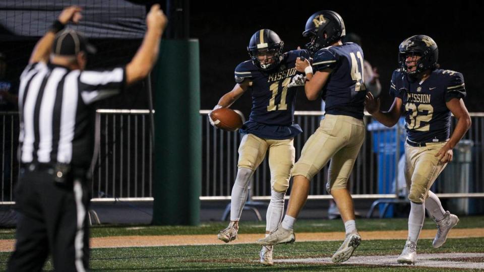 From left, Luke Terry scores and is celebrated by Lukas Elmerick and Isaac Townsend. Mission Prep’s playoff run ended with a 20-14 overtime loss to Kerman High School on Nov. 17, 2023, in the CIF Central Section Division 3 football playoffs.