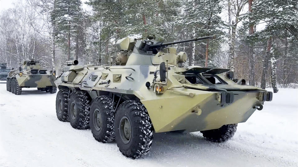 In this photo taken from video released by the Russian Defense Ministry Press Service, military vehicles of Russian peacekeepers parked waiting to transported onto Russian military planes at an airfield outside Moscow, in Russia to fly to Kazakhstan Thursday, Jan. 6, 2022. A Russia-led military alliance, the Collective Security Treaty Organization, said early Thursday that it would send peacekeeper troops to Kazakhstan at the request of President Kassym-Jomart Tokayev. (Russian Defense Ministry Press Service via AP)