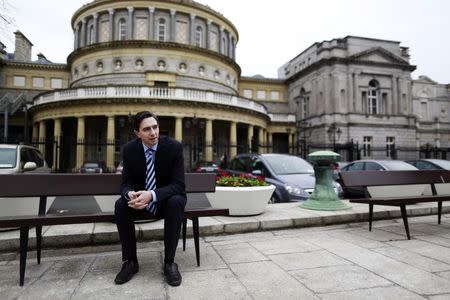 Ireland's Minister of State for Finance Simon Harris poses for a picture in front of Leinster House in Dublin March 5, 2015. REUTERS/Cathal McNaughton