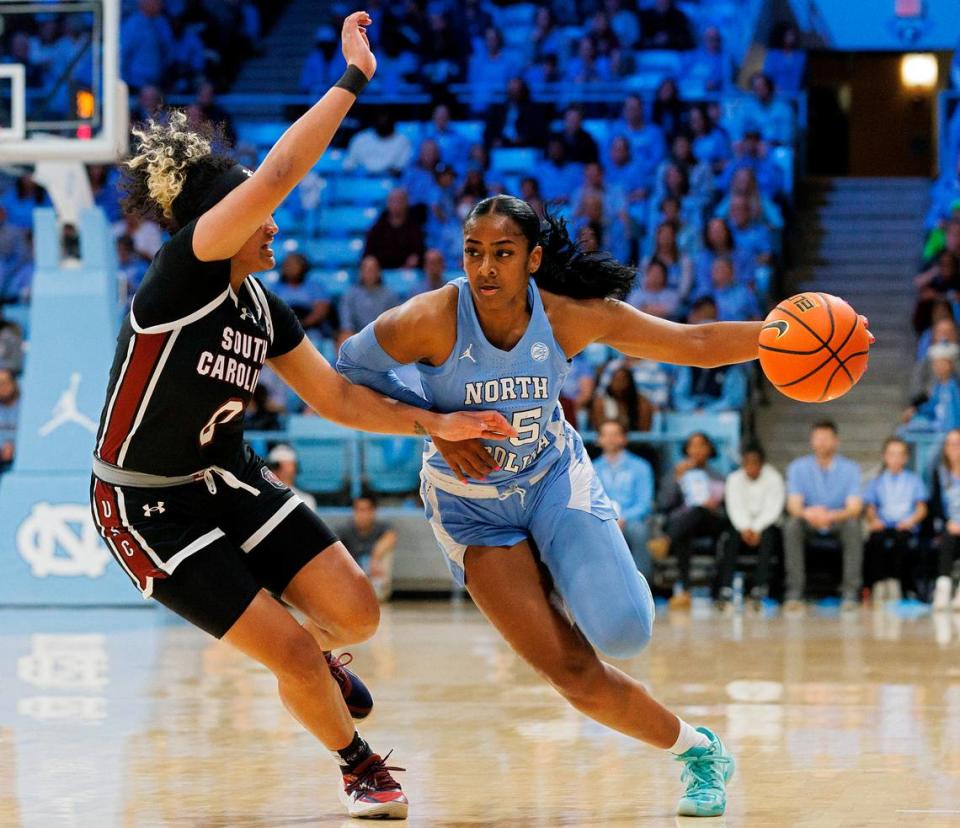 North Carolina’s Deja Kelly drives past South Carolina’s Te-Hina Paopao during the first half of the Tar Heels’ 65-58 loss on Thursday, Nov. 30, 2023, at Carmichael Arena in Chapel Hill, N.C.