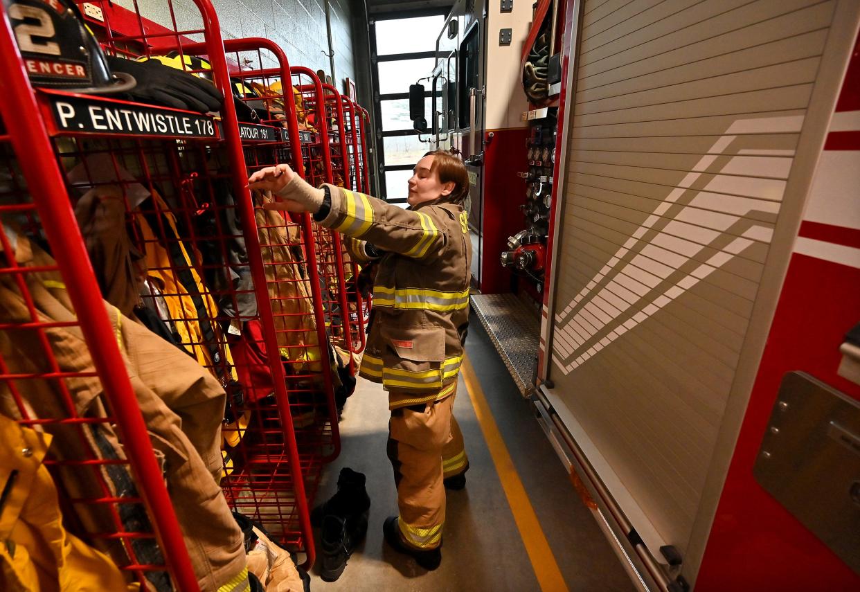 Recently hired Spencer firefighter Shannon Latour-Jodrey puts on her gear.