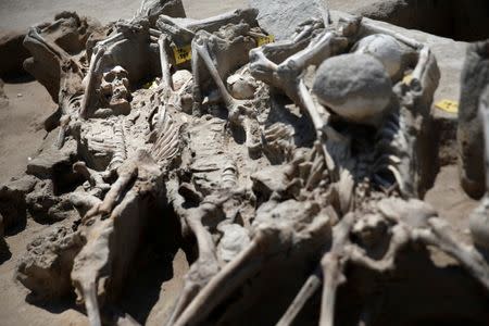 Skeletal remains, with iron shackles on their wrists, are piled on top of each other at the ancient Falyron Delta cemetery in Athens, Greece, July 27, 2016. REUTERS/Alkis Konstantinidis