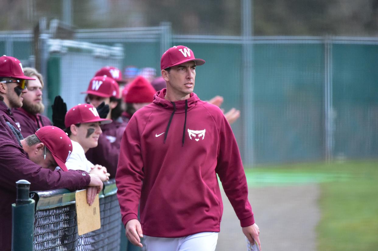 Aaron Swick (pictured during a 2023 game while coaching Willamette) is the new head baseball coach at The College of Wooster.