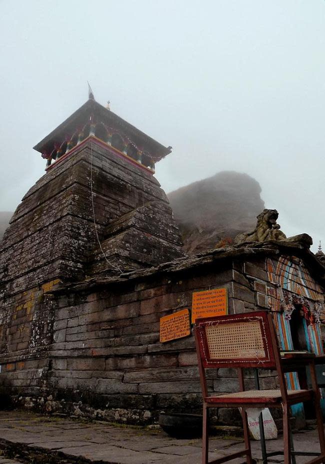 The priest’s chair is placed invitingly outside the temple but we choose to sit on the cool stones in the small courtyard. The priests of the Tungnath temple are local Brahmins from the village of Maku, a few thousand feet below. In all the other Kedar temples, including Kedarnath, the priests are from Udupi or Kerala, a tradition dating back to Adi Sankara’s reforms. <p><b>View Part 2 of this slideshow: <a href="http://in.lifestyle.yahoo.com/photos/chandrashila-in-the-arms-of-shiva-1329741657-slideshow/" data-ylk="slk:Chandrashila - in the arms of Shiva;elm:context_link;itc:0;sec:content-canvas;outcm:mb_qualified_link;_E:mb_qualified_link;ct:story;" class="link  yahoo-link">Chandrashila - in the arms of Shiva</a><br><a href="http://in.lifestyle.yahoo.com/photos/chandrashila-in-the-arms-of-shiva-1329741657-slideshow/" data-ylk="slk:;elm:context_link;itc:0;sec:content-canvas;outcm:mb_qualified_link;_E:mb_qualified_link;ct:story;" class="link  yahoo-link"> </a></b></p>