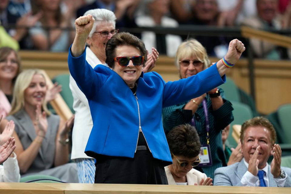 Billie Jean King stands and gestures to the crowd at Wimbledon 2023.