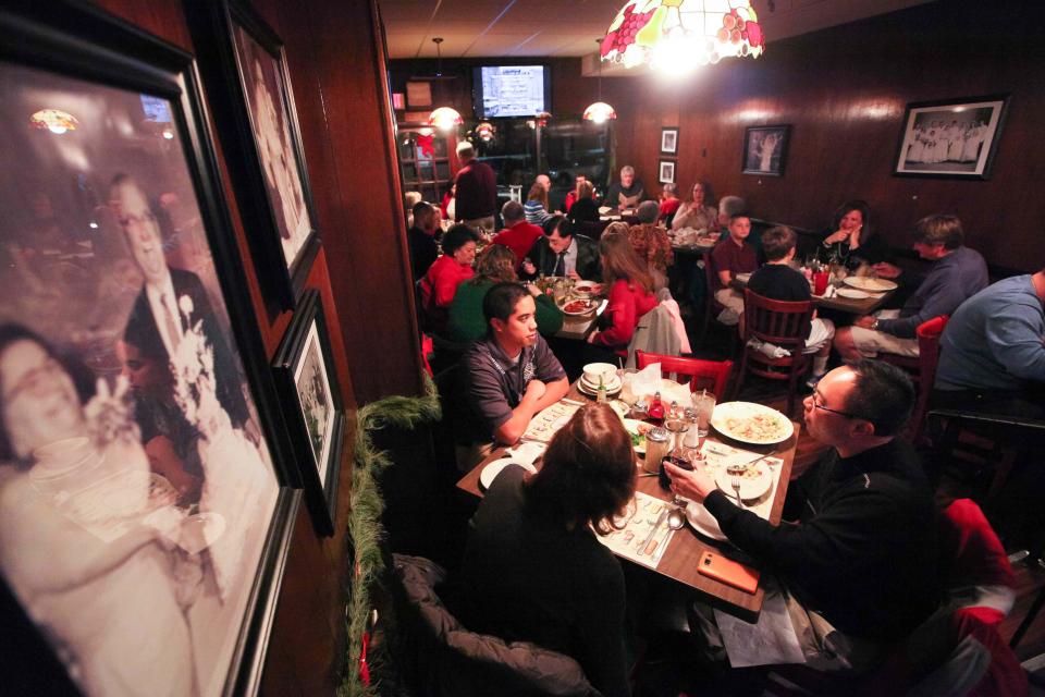 This 2013 photo shows customers dining at Mrs. Robino's Feast of Seven Fishes dinner on Christmas Eve. The Wilmington restaurant has been open since 1940.