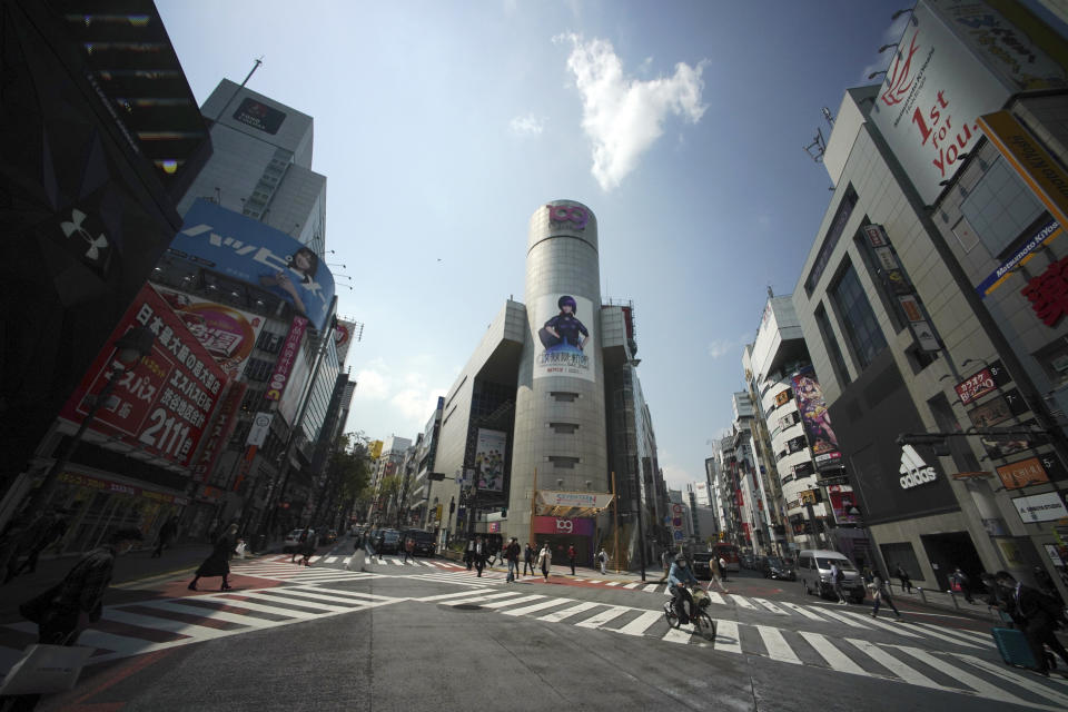 Fewer than usual people at Shibuya Scramble Crossing is seen Wednesday, April 8, 2020, in Tokyo. Japanese Prime Minister Shinzo Abe declared a state of emergency Tuesday for Tokyo and six other prefectures to ramp up defenses against the spread of the coronavirus. (AP Photo/Eugene Hoshiko)