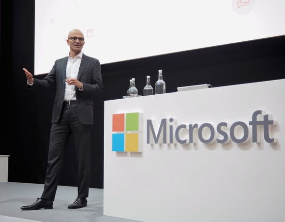 Microsoft CEO Satya Nadella on a stage giving a talk.