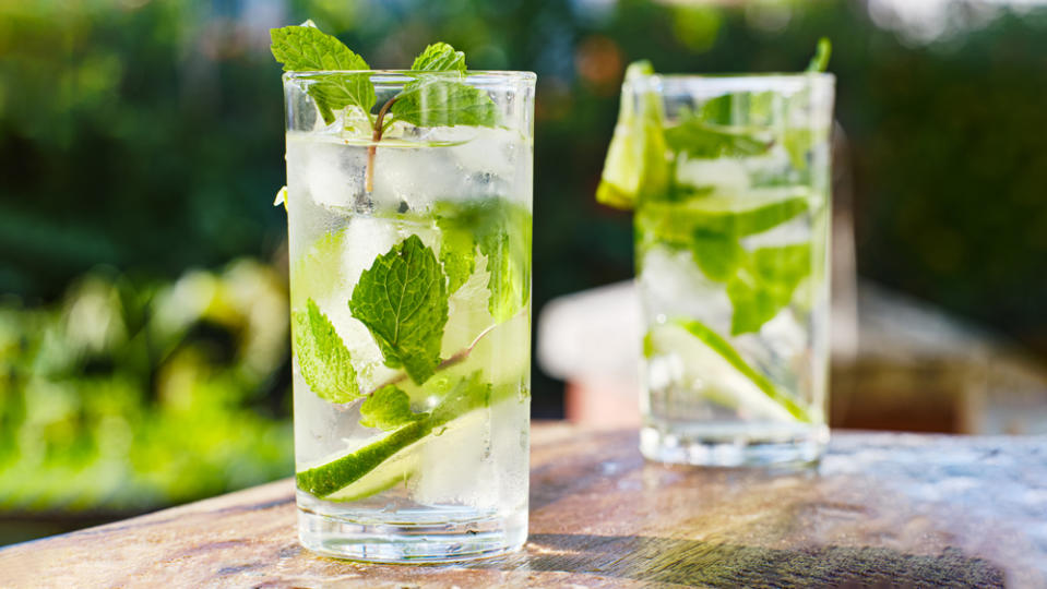 two mojito cocktails on wooden table top - Credit: Joshua Resnick/Adobe Stock