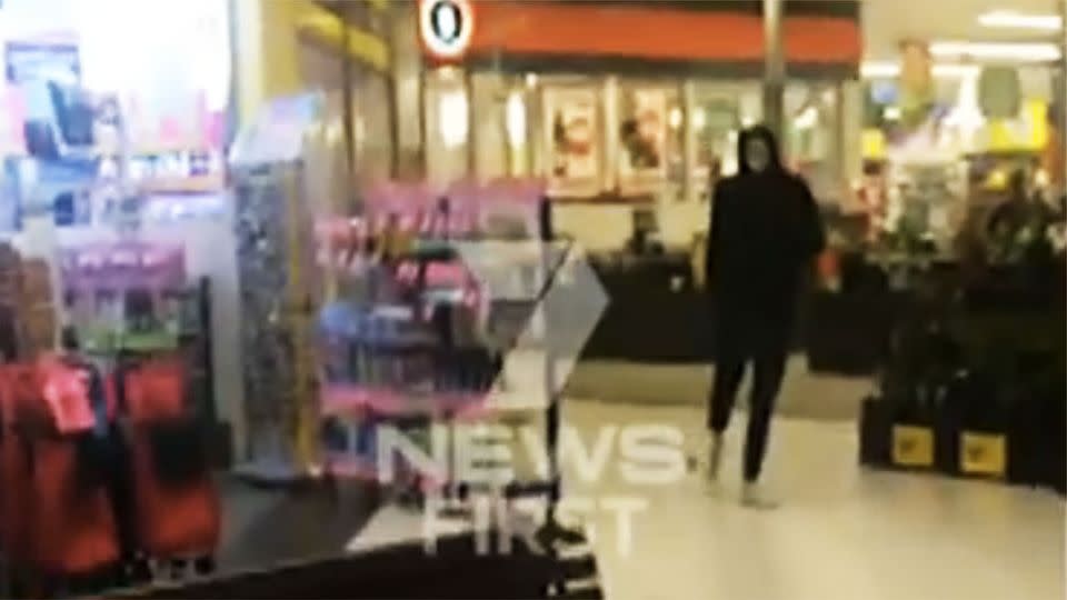 A masked thug stood by as his accomplices robbed the supermarket. Photo: 7 News