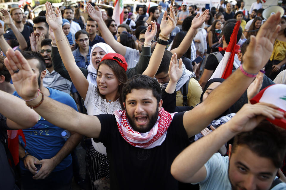 University students chant slogans against the government, in Beirut, Lebanon, Tuesday, Nov. 12, 2019. Protesters in Lebanon resumed demonstrations on Tuesday blocking some roads and governmental institutions. (AP Photo/Bilal Hussein)