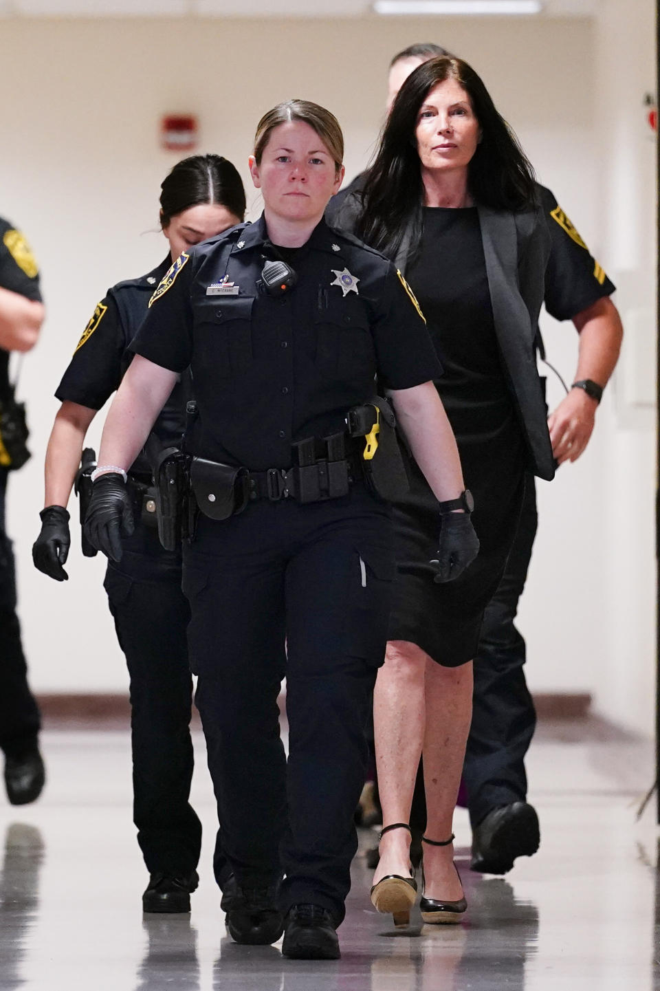 Former Pennsylvania Attorney General Kathleen Kane, right, is led to court as she arrives for a hearing on an alleged probation violation, at the Montgomery County Courthouse in Norristown, Pa., Monday, May 23, 2022. Pennsylvania's former top law enforcement officer, who served jail time for leaking secret investigative files and lying about it, faces the prospect of more time behind bars after she was arrested for drunken driving in March. (AP Photo/Matt Rourke)