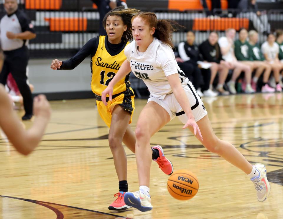 Norman North's Olivia Watkins drives to the basket as Sand Springs' Tay'Ja Butler defends during the Putnam City Invitational high school basketball tournament at Putnam City high school in Oklahoma City, Thursday, Jan. 4, 2024.