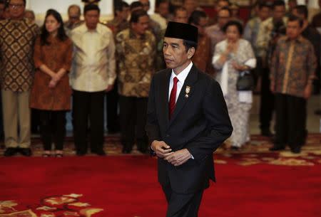 Indonesia's President Joko Widodo walks after swearing-in Basuki Tjahaja Purnama as Jakarta governor at the Presidential palace in Jakarta, November 19, 2014. REUTERS/Beawiharta