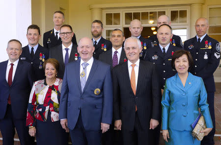 Australia's Craig Challen and Richard Harris, who were part of the Thailand cave rescue team, stand together with members of the Australian Federal Police, Australia's Governor-General Peter Cosgrove, Australian Prime Minister Malcolm Turnbull and other officials after a ceremony at Government House in Canberra, Australia, July 24, 2018. AAP/Sean Davey/via REUTERS