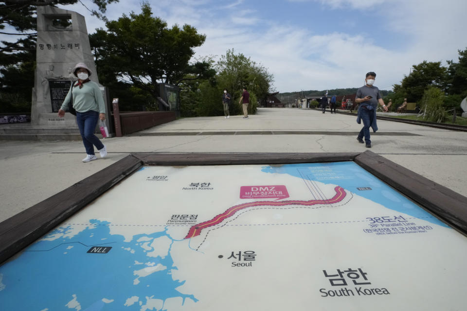 Visitors walk by a map of two Koreas showing North Korea's capital Pyongyang and South Korea's capital Seoul at the Imjingak Pavilion in Paju, near the border with North Korea, South Korea, Friday, Sept. 24, 2021. North Korean leader Kim Jong Un’s powerful sister, Kim Yo Jong, said Friday, North Korea is willing to resume talks with South Korea if it doesn’t provoke the North with hostile policies and double standards. (AP Photo/Ahn Young-joon)