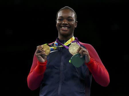 2016 Rio Olympics - Boxing - Victory Ceremony - Women's Middle (75kg) Victory Ceremony - Riocentro - Pavilion 6 - Rio de Janeiro, Brazil - 21/08/2016. Gold medallist Claressa Shields (USA) of USA poses with her medals from London 2012 and Rio 2016 (L). REUTERS/Peter Cziborra