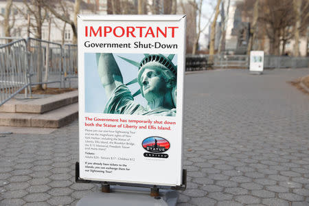 A sign announcing the closure of the Statue of Liberty, due to the U.S. government shutdown, sits near the ferry dock to the Statue of Liberty at Battery Park in Manhattan, New York, U.S. January 21, 2018. REUTERS/Shannon Stapleton